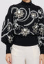 Maglione nero con ricami floreali bianchi e dettagli in paillettes